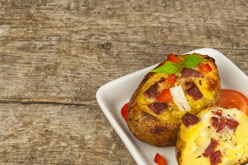 Stuffed baked potatoes on a wooden table. Healthy food. Homework dinner.