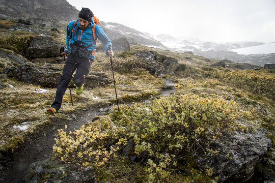 Hiker running on mountain trail