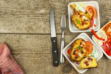 Stuffed baked potatoes on a wooden table. Healthy food. Homework dinner.