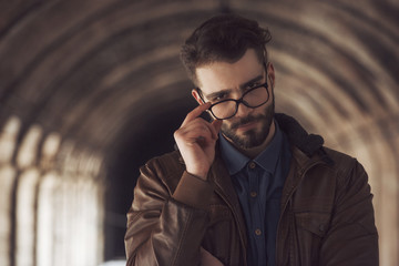 portrait of a young archaeologist man in fashionable outfit 