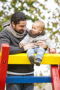 Father and son playing together on jungle gym, Osijek, Croatia
