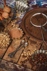 Roasted black and green coffee beans and ground coffee in the plate