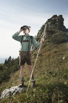 Germany, Bavaria, Boy looking through binoculars in the mountains