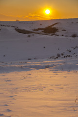 Sunset over winter snow fields