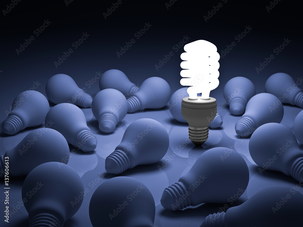 Leinwandbilder energy saving light bulb one glowing compact fluorescent lightbulb standing out from unlit incandesc