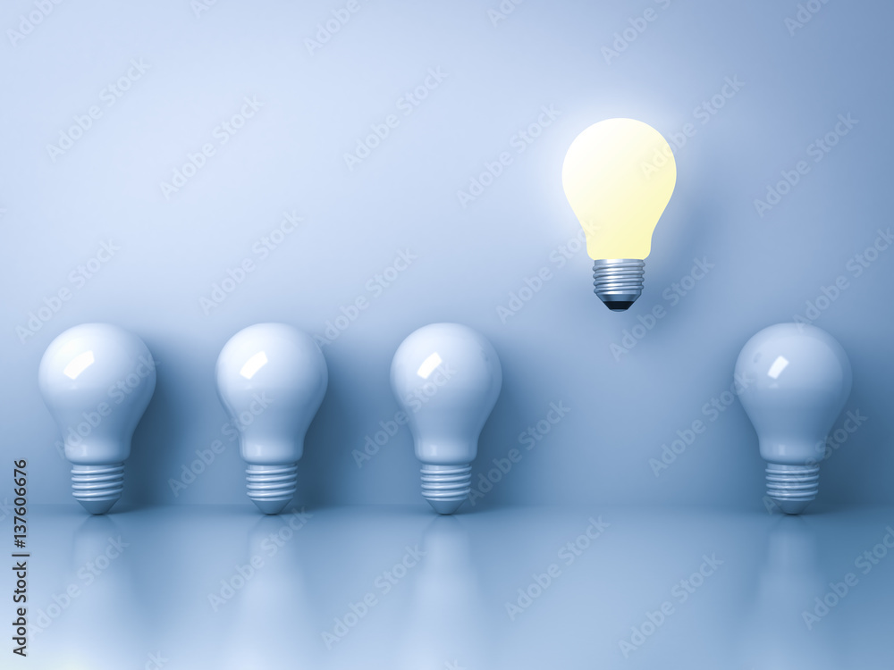 Poster one glowing light bulb standing out from the unlit incandescent bulbs on blue background with reflec