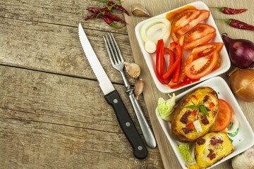 Stuffed baked potatoes on a wooden table. Healthy food. Homework dinner.