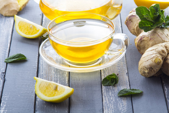 tea ginger lemon mint vintage wood background
