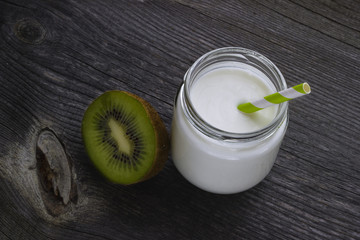 Fresh homemade yogurt with kiwi fruit on old wooden table