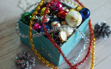 Paper box filled with colorful Christmas decorations, isolated o