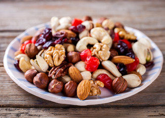 Nuts and dried fruit mix. Concept of Healthy Food. Vintage wooden background. Copy space for Text. selective focus