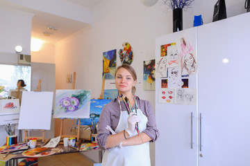 Women beautiful painter posing and smiling, laughing into camera