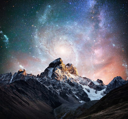 Fantastic starry sky. Snow-capped peaks. Main Caucasian Ridge. C