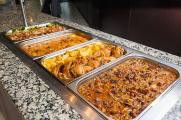 Heated cages with meat dishes