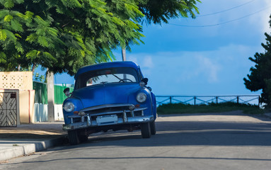 Amerikanischer blauer Oldtimer parkt in der Seitenstraße von Varadero Kuba - Serie Kuba Reportage