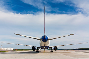 Back view of plane. Long-haul aircraft. Ready to takeoff on the runway. Passenger airliner takes off. Passenger commercial air transportation.