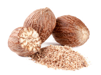 Three nutmeg and powder isolated on white background