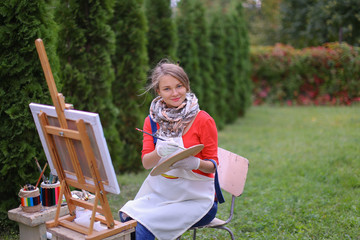 Women beautiful painter posing and smiling, laughing into camera