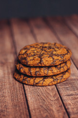 oatmeal cookies covered with chocolate glaze on a wooden table