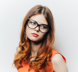 sad red-haired woman wearing glasses