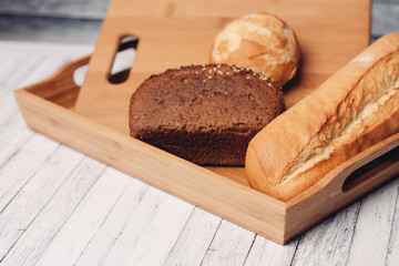 Fototapeta na wymiar rye bread, baguette, loaf on a cutting board