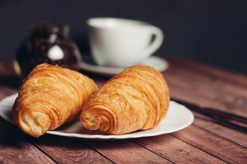 croissants, a cup in the background