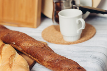 mug on the board and a loaf