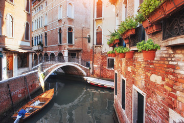 Fototapeta na wymiar Gondolas on canal in Venice. is a popular tourist destination of Europe