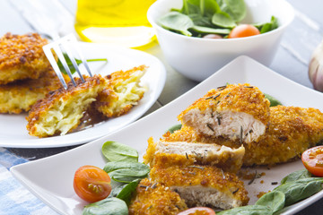 Food fried breading chicken spinach salad tomatoes pancakes from potatoes
