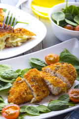 Food fried breading chicken spinach salad tomatoes pancakes from potatoes
