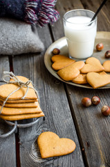 Valentines day heart shaped cookies and glass of milk.