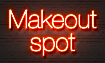 Naklejka na ściany i meble Makeout spot neon sign on brick wall background.