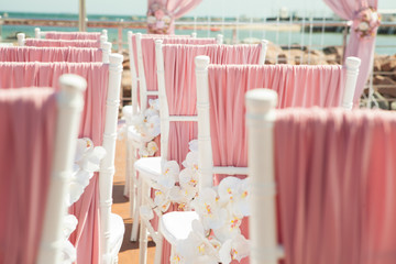 Wedding outdoor decoration of chairs with flowers