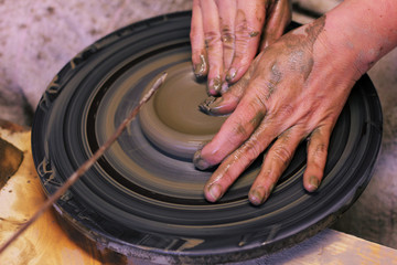 closeup of hands working on pottery wheel, clay pot 