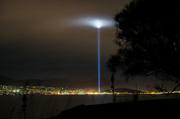 Nighttime view on Hobart, Tasmania from eastern shore shows a strobe of light during 2013 Dark Mofo Art festival