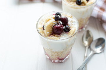 Healthy breakfast. Oatmeal with bananas, berries and honey