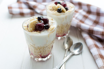 Healthy breakfast. Oatmeal with bananas, berries and honey