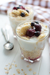 Healthy breakfast. Oatmeal with bananas, berries and honey