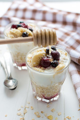 Healthy breakfast. Oatmeal with bananas, berries and honey