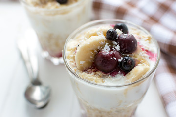 Healthy breakfast. Oatmeal with bananas, berries and honey
