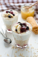 Healthy breakfast. Oatmeal with bananas, berries and honey