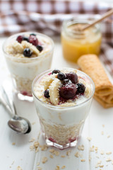 Healthy breakfast. Oatmeal with bananas, berries and honey