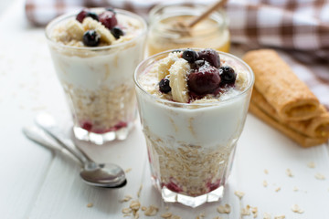 Healthy breakfast. Oatmeal with bananas, berries and honey