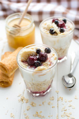 Healthy breakfast. Oatmeal with bananas, berries and honey