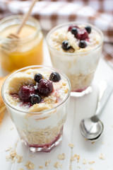 Healthy breakfast. Oatmeal with bananas, berries and honey
