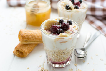 Healthy breakfast. Oatmeal with bananas, berries and honey