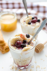 Healthy breakfast. Oatmeal with bananas, berries and honey