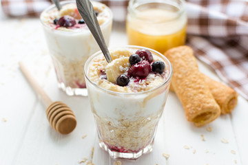 Healthy breakfast. Oatmeal with bananas, berries and honey
