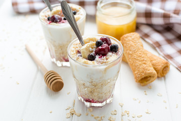 Healthy breakfast. Oatmeal with bananas, berries and honey