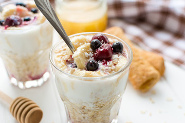 Healthy breakfast. Oatmeal with bananas, berries and honey